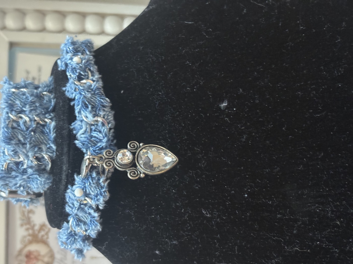 Frayed denim choker with a teardrop crystal pendant and a matching frayed denim cuff.